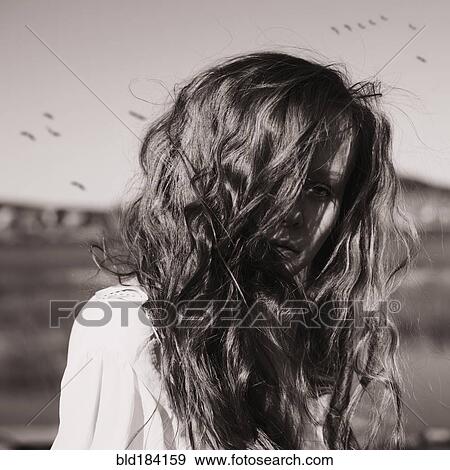 Caucasian woman standing in rural field View Large Photo Image Stock Photo - Caucasian woman standing in rural field. Fotosearch