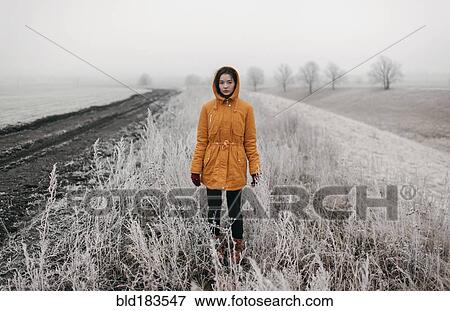 Caucasian woman standing in snowy field View Large Photo Image Stock Photo - Caucasian woman standing in snowy field. Fotosearch