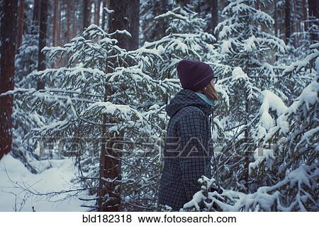Caucasian woman standing in snowy forest View Large Photo Image Stock Photo - Caucasian woman standing in snowy forest. Fotosearch