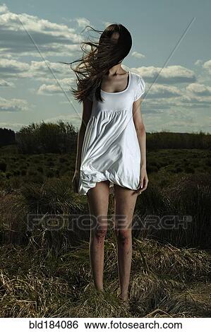 Caucasian woman standing in windy field View Large Photo Image Stock Photograph - Caucasian woman standing in windy field. Fotosearch