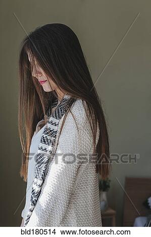 Caucasian woman standing indoors View Large Photo Image Picture - Caucasian woman standing indoors. Fotosearch
