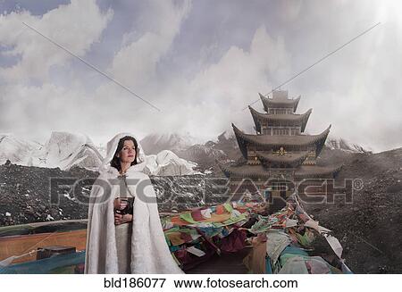 Stock Photo - Caucasian woman standing near monument, Xining, Qinghai, China. Fotosearch