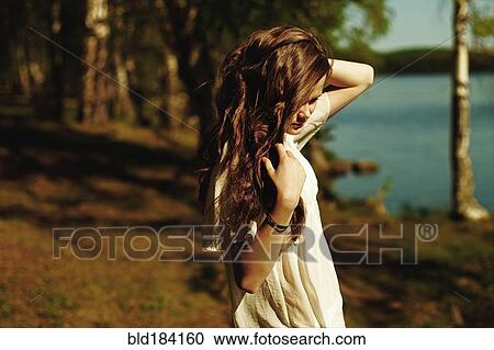 Caucasian woman standing near rural lake View Large Photo Image Stock Image - Caucasian woman standing near rural lake. Fotosearch