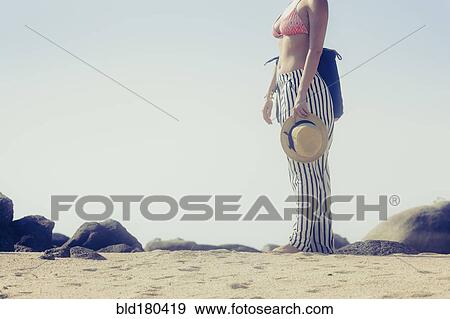 Caucasian woman standing on beach View Large Photo Image Stock Photo - Caucasian woman standing on beach. Fotosearch