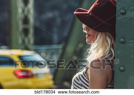 Picture - Caucasian woman standing on bridge. Fotosearch