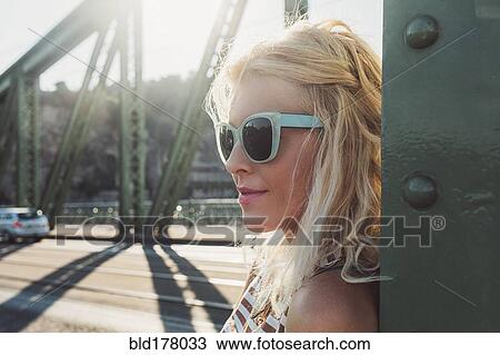 Stock Image - Caucasian woman standing on bridge. Fotosearch