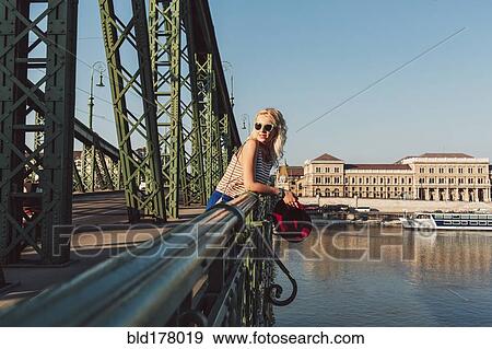 Stock Photo - Caucasian woman standing on bridge. Fotosearch