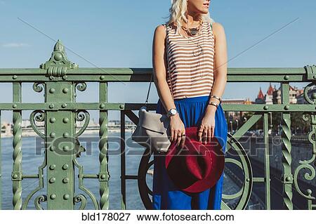 Stock Photo - Caucasian woman standing on bridge. Fotosearch