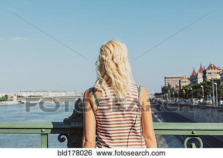 Stock Photograph - Caucasian woman standing on bridge. Fotosearch
