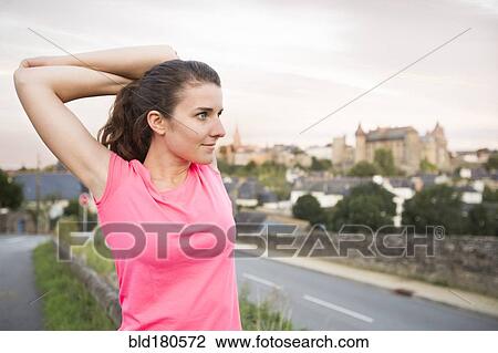 Caucasian woman stretching outdoors View Large Photo Image Stock Image - Caucasian woman stretching outdoors. Fotosearch