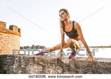 Stock Photograph - Caucasian woman stretching outdoors. Fotosearch