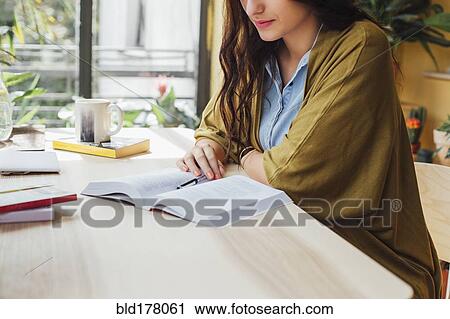 Caucasian woman studying at desk View Large Photo Image Stock Image - Caucasian woman studying at desk. Fotosearch