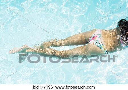 Stock Photograph - Caucasian woman swimming in pool. Fotosearch