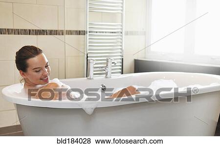 Caucasian woman taking bubble bath in bathroom View Large Photo Image Stock Photo - Caucasian woman taking bubble bath in bathroom. Fotosearch