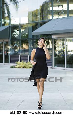 Caucasian woman talking on cell phone outdoors View Large Photo Image Stock Image - Caucasian woman talking on cell phone outdoors. Fotosearch