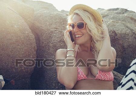 Stock Photo - Caucasian woman talking on cell phone outdoors. Fotosearch