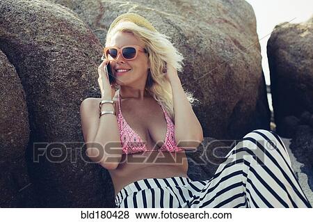 Stock Photo - Caucasian woman talking on cell phone outdoors. Fotosearch