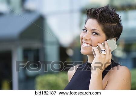 Stock Photo - Caucasian woman talking on cell phone. Fotosearch