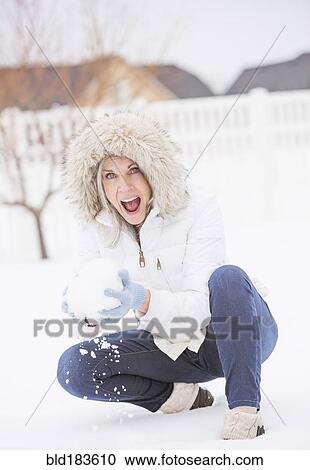 Caucasian woman throwing snowball in snow View Large Photo Image Stock Image - Caucasian woman throwing snowball in snow. Fotosearch