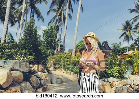 Caucasian woman using cell phone on beach View Large Photo Image Stock Image - Caucasian woman using cell phone on beach. Fotosearch