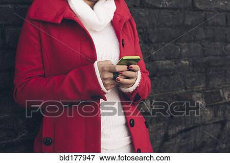 Caucasian woman using cell phone outdoors View Large Photo Image Stock Photo - Caucasian woman using cell phone outdoors. Fotosearch