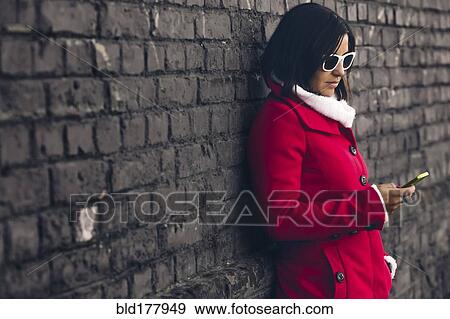 Caucasian woman using cell phone outdoors View Large Photo Image Stock Photo - Caucasian woman using cell phone outdoors. Fotosearch