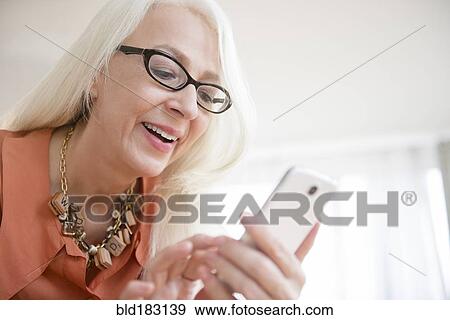 Stock Photo - Caucasian woman using cell phone. Fotosearch