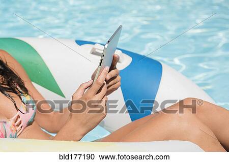 Caucasian woman using digital tablet in swimming pool View Large Photo Image Stock Image - Caucasian woman using digital tablet in swimming pool. Fotosearch