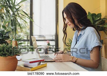 Caucasian woman using laptop at desk View Large Photo Image Stock Image - Caucasian woman using laptop at desk. Fotosearch
