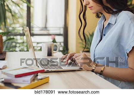 Caucasian woman using laptop at desk View Large Photo Image Stock Image - Caucasian woman using laptop at desk. Fotosearch