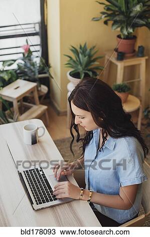 Caucasian woman using laptop at desk View Large Photo Image Stock Image - Caucasian woman using laptop at desk. Fotosearch