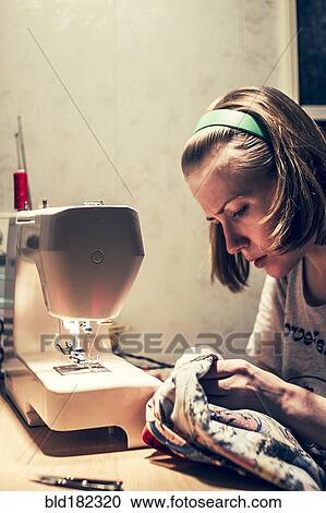Caucasian woman using sewing machine View Large Photo Image Stock Image - Caucasian woman using sewing machine. Fotosearch