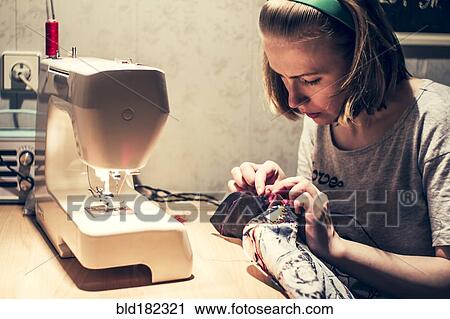 Caucasian woman using sewing machine View Large Photo Image Stock Image - Caucasian woman using sewing machine. Fotosearch