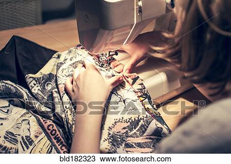 Caucasian woman using sewing machine View Large Photo Image Stock Image - Caucasian woman using sewing machine. Fotosearch
