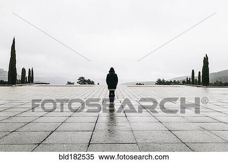 Caucasian woman walking in concrete courtyard View Large Photo Image Stock Photography - Caucasian woman walking in concrete courtyard. Fotosearch