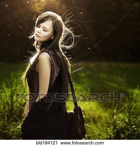 Caucasian woman walking in field View Large Photo Image Stock Image - Caucasian woman walking in field. Fotosearch