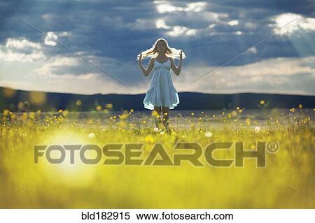 Caucasian woman walking in rural field View Large Photo Image Stock Photography - Caucasian woman walking in rural field. Fotosearch