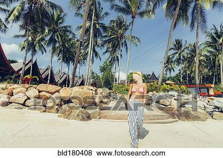 Caucasian woman walking on beach View Large Photo Image Stock Photo - Caucasian woman walking on beach. Fotosearch