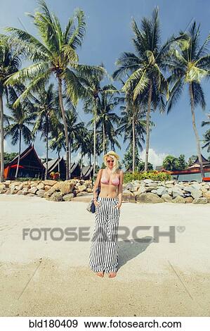 Caucasian woman walking on beach View Large Photo Image Stock Photo - Caucasian woman walking on beach. Fotosearch