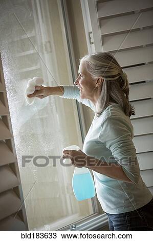 Caucasian woman washing window View Large Photo Image Stock Image - Caucasian woman washing window. Fotosearch