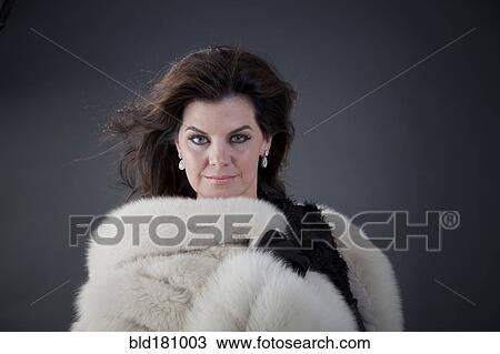 Stock Image - Caucasian woman wearing fur coat. Fotosearch