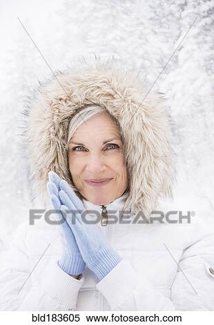 Stock Photography - Caucasian woman wearing fur hood in snow. Fotosearch