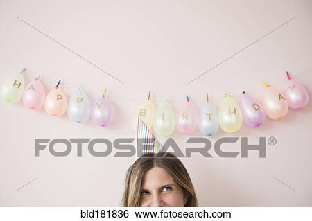 Caucasian woman wearing party hat at birthday View Large Photo Image Stock Photograph - Caucasian woman wearing party hat at birthday. Fotosearch