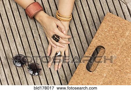 Stock Photo - Caucasian woman with jewelry, purse and sunglasses. Fotosearch