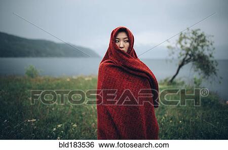 Caucasian woman wrapped in blanket in rural field View Large Photo Image Stock Photograph - Caucasian woman wrapped in blanket in rural field. Fotosearch