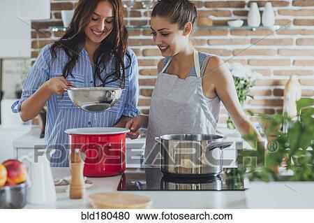 Caucasian women cooking in kitchen View Large Photo Image Stock Image - Caucasian women cooking in kitchen. Fotosearch