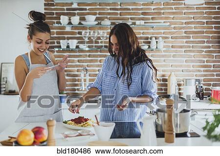 Caucasian women cooking pasta in kitchen View Large Photo Image Stock Photograph - Caucasian women cooking pasta in kitchen. Fotosearch