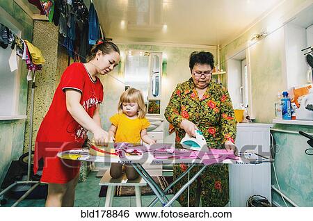 Caucasian women ironing laundry View Large Photo Image Stock Photograph - Caucasian women ironing laundry. Fotosearch