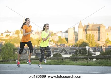 Stock Photo - Caucasian women jogging outdoors. Fotosearch
