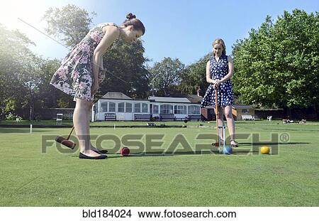 Caucasian women playing croquet on lawn View Large Photo Image Picture - Caucasian women playing croquet on lawn. Fotosearch